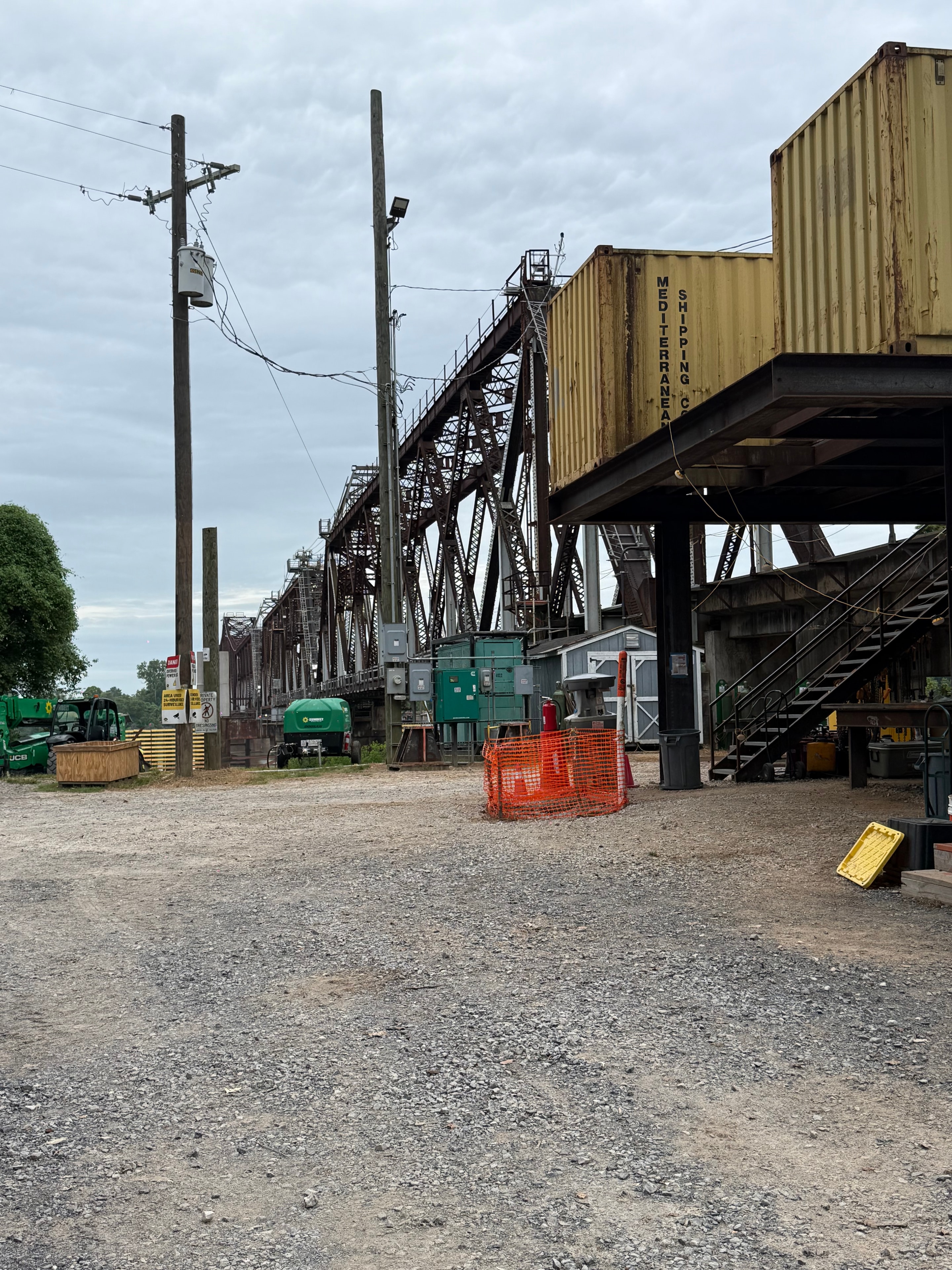 Electrical raceway installation on rotating railroad bridge — ground-level view